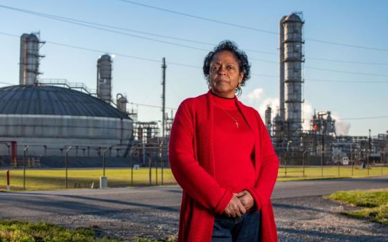 Sharon Lavigne, an environmental justice activist and founder of Rise St. James, stands in front of a chemical plant near her home in St. James Civil Parish, La., March 13, 2022.