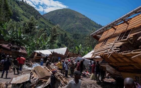 Congolese civilians gather in the village of Nyamukubi, May 6, 2023, after the death of their family members following flooding and landslides that destroyed buildings and forced aid workers to gather mud-clad corpses into piles. (OSV News/Reuters)