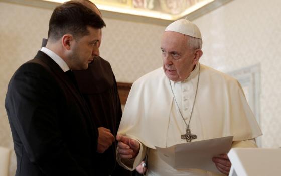 President Volodymyr Zelenskyy, wearing a suit, stands next to Pope Francis while in conversation