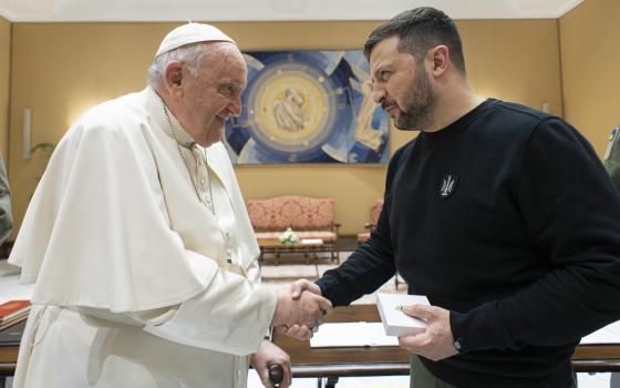 Pope Francis and Ukrainian President Volodymyr Zelenskyy shake hands after their meeting at the Vatican May 13, 2023. (CNS photo/Vatican Media)