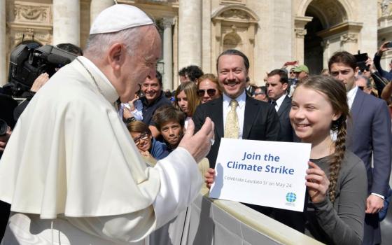 Pope Francis greets Swedish climate activist Greta Thunberg during his general audience in St. Peter's Square at the Vatican in this file photo from April 17, 2019. In a new book, Pope Francis writes that people must learn from young people to care for the poor and for the environment. (CNS photo/Vatican Media)