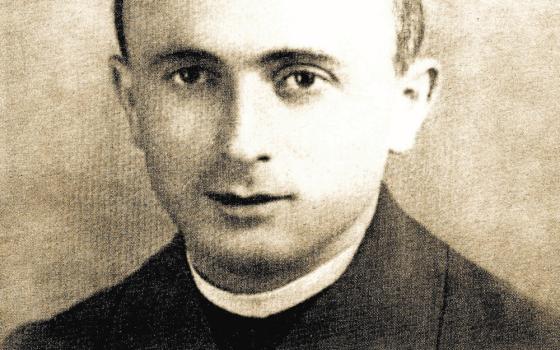 A black and white photo of a white man in a clerical collar