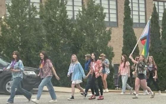 On the last day of class for seniors at St. Thomas Aquinas in Dover, New Hampshire, soon-to-be graduates carry a flag in support of the school's LGBTQ community and four teachers whose contracts were not renewed.