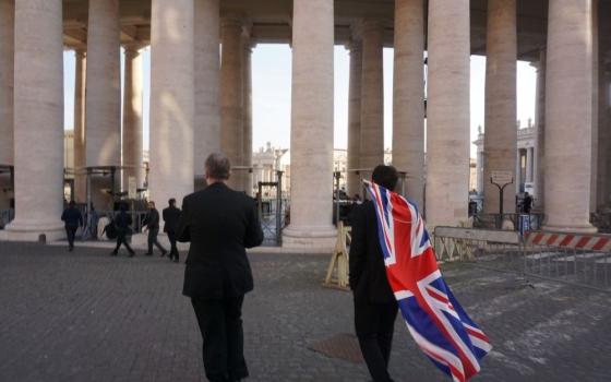 British seminarians fold a Union Jack flag as they approach St. Peter's Square. (Courtesy of Ryan Hawkes) 