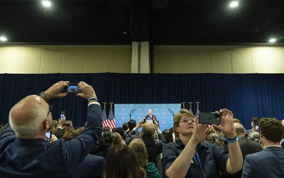 Supporters take pictures as President Joe Biden speaks at a Democratic National Committee event at the Gaylord National Resort and Convention Center, Sept. 8, 2022, in Oxon Hill, Maryland. (AP photo/Alex Brandon)