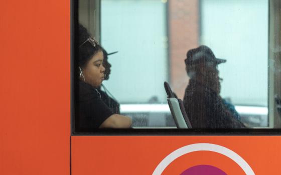 People riding on a bus (Unsplash/Mark Cook)