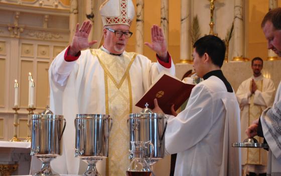 Bishop Christopher J. Coyne of Burlington, Vt., blesses holy oil during the chrism Mass at St. Joseph Cathedral April 16, 2019. During the Mass, Bishop Coyne officially announced a the cause for canonization of Bishop Louis deGoesbriand, the first bishop of Burlington, had been opened. (CNS photo/Cori Fugere Urban, Vermont Catholic) 