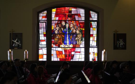 A stained-glass window depicting the descent of the Holy Spirit upon Mary and the apostles is seen during a confirmation Mass May 5, 2022, at Holy Family Church in Queens, N.Y. Auxiliary Bishop James Massa of Brooklyn, N.Y., conferred the sacrament of confirmation on 26 students from the parish school and religious education program during the liturgy. (CNS photo/Gregory A. Shemitz)