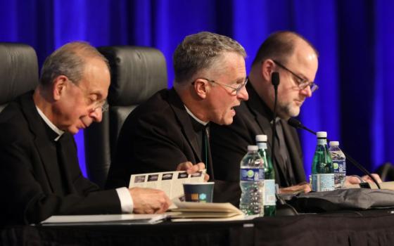 Archbishop Timothy P. Broglio (center) of the U.S. Archdiocese for the Military Services, who is president of the U.S. Conference of Catholic Bishops, speaks June 15 during the bishops' spring plenary assembly in Orlando, Fla. Also pictured are Archbishop William E. Lori of Baltimore, USCCB vice president (left), and Fr. Michael J.K. Fuller, USCCB general secretary. (OSV News /Bob Roller)