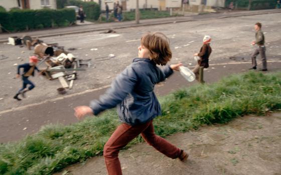 In this image from the PBS documentary series "Once Upon a Time in Northern Ireland," Anne Marie, 10, throws bottles at British troops during a riot in Belfast, Northern Ireland, in 1981. (PBS/Courtesy of Magnum Photos/Peter Marlow)