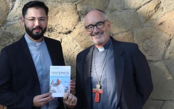 Fr. Christian Barone (left) and Cardinal Michael Czerny are pictured with their book in Italian, "Fraternity: Sign of the Times," in Rome on Sept, 30, 2021. 