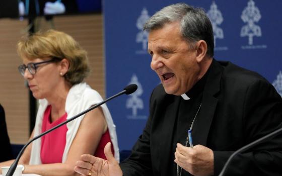 Secretary General of the Synod of Bishops Cardinal Mario Grech, right, delivers his speech during a presentation of the new guidelines for the Synod of Bishops at the Vatican June 20. At left is Helena Jeppesen Spuhler, a synod participant from Switzerland who was among those presenting the document. (AP/Domenico Stinellis)