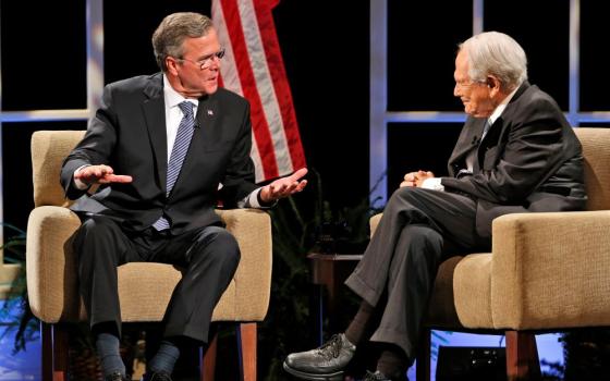 Pat Robertson, right, speaks with Republican presidential candidate Jeb Bush during a presidential candidate forum at Regent University in Virginia Beach, Va., Oct. 23, 2015. Robertson, who died June 8 at age 93, ran for the Republican nomination for president in 1988, coming in behind both George H.W. Bush and Bob Dole. (AP/Steve Helber)