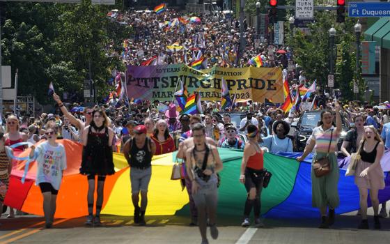 The Pittsburgh Pride parade crosses the Andy Warhol Bridge from downtown Pittsburgh June 3. Bishop David Zubik canceled a planned June 11 Mass in solidarity with LGBTQ people after a flyer advertising it as a "Pride Mass" was circulated on social media and anti-LGBTQ Catholic influencers urged their followers to contact him (AP/Gene J. Puskar)