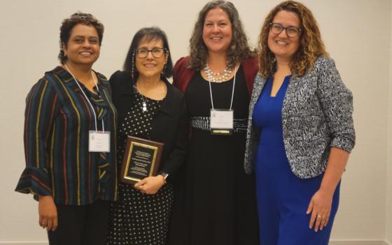 Cecilia Gonzalez-Andrieu (second from left) receives the 2023 Ann O'Hara Graff Award June 8 at the annual convention of the Catholic Theological Society of America. Among those honoring the theologian at the award ceremony were (from left) Susan Abraham of the Pacific School of Religion, Layla Karst of Loyola Marymount and Jennifer Owens Jofré of St. Louis University. (NCR/Heidi Schlumpf)