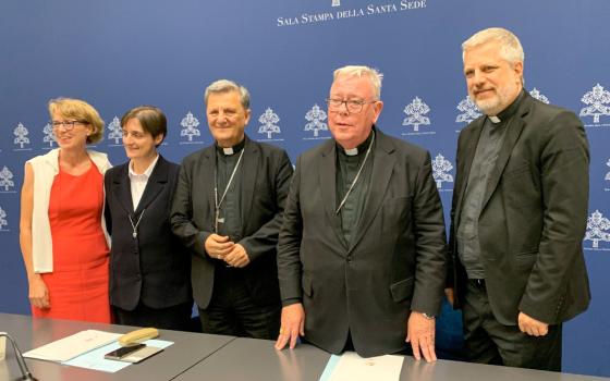 The people who presented the working document for the Synod of Bishops pose for a photo in the Vatican press office June 20. From the left are Helena Jeppesen-Spuhler, a synod participant from Switzerland; Sr. Nadia Coppa, president of the women's International Union of Superiors General; Cardinal Mario Grech, secretary-general of the synod; Cardinal Jean-Claude Hollerich, relator general of the synod; and Jesuit Fr. Giacomo Costa, a consultant to the synod. (CNS/Cindy Wooden)