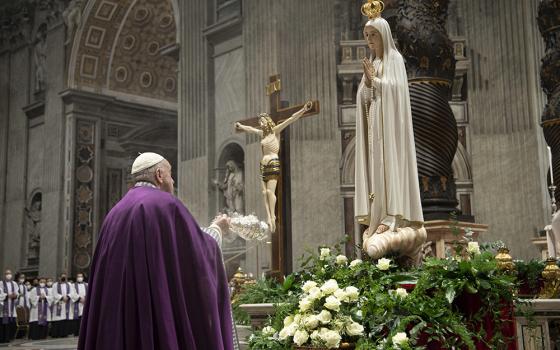 Pope Francis burns incense in front of a Marian statue after consecrating the world and, in particular, Ukraine and Russia to the Immaculate Heart of Mary during a Lenten penance service in St. Peter's Basilica March 25, 2022, at the Vatican. A year later, he asked Catholics worldwide to renew the consecration and pray for peace. (CNS/Vatican Media)