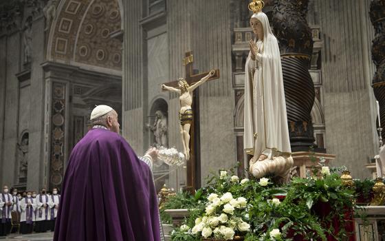 Pope Francis burns incense in front of a Marian statue after consecrating the world and, in particular, Ukraine and Russia to the Immaculate Heart of Mary during a Lenten penance service in St. Peter's Basilica March 25, 2022, at the Vatican. A year later, he asked Catholics worldwide to renew the consecration and pray for peace. (CNS/Vatican Media)