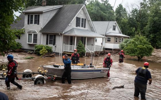 Emergency personnel maneuver a boat used to rescue residents of flooded homes in Stony Point, N.Y., July 9, 2023. Severe storms that left at least one dead in Orange County, dumped heavy rainfall at intense rates over parts of the Northeast, forcing road closures, water rescues and urgent warnings about life-threatening flash floods.