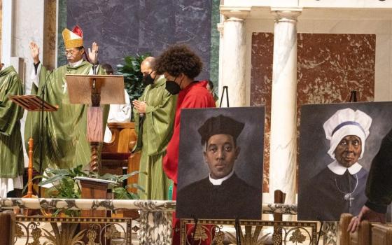 Auxiliary Bishop Roy E. Campbell Jr. of Washington, president of the National Black Catholic Congress, celebrates Mass Feb. 6, 2022, at St. Matthew's Cathedral to mark Black History Month. The 13th National Black Catholic Congress is July 20-23. The portraits on display are of Fr. Augustus Tolton and Mother Mary Elizabeth Lange, candidates for sainthood. (CNS photo/Javier Diaz, Catholic Standard)