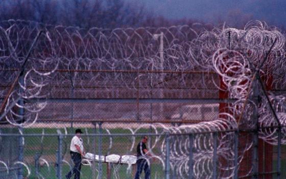 In this April 13, 1993, file photo, the body of the seventh prisoner killed in a riot at the Southern Ohio Correctional Facility in Lucasville, Ohio, is removed.