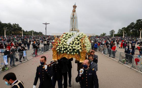The statue of Our Lady of Fatima is carried May 13, 2021, at the Marian shrine of Fatima in central Portugal.