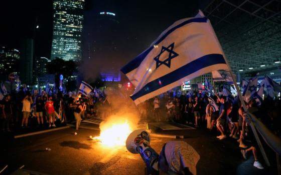 Israeli flag is seen among protesters in Tel Aviv.