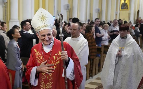Cardinal Matteo Zuppi greets parishioners after celebrating Mass at the Cathedral of the Immaculate Conception in Moscow June 29. Zuppi's June 28-29 Moscow visit marked the second round of a mission to bring peace to Ukraine. (AP/Alexander Zemlianichenko)