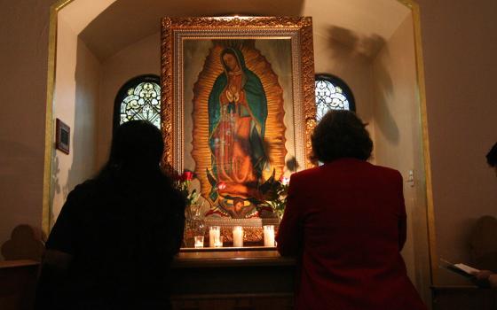 Two women pray before a shrine dedicated to Our Lady of Guadalupe in this 2006 file photo. Contributor Catalina Morales Bahena always felt that her paternal grandmother and Our Lady of Guadalupe "were so important to my formation as a Catholic woman. I know they both guide my path in my ministry work." (CNS/The Catholic Sun/Robert DeFrancesco)