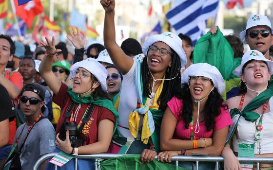 Pilgrims cheer prior to the opening Mass for World Youth Day at Eduardo VII Park in Lisbon, Portugal, Aug. 1, 2023. (OSV News/Bob Roller)