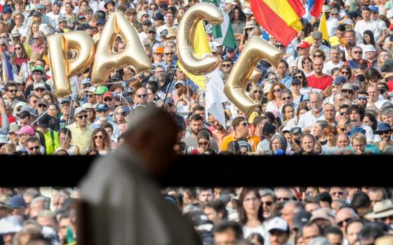 The word “PACE,” peace, is seen in the crowd gathered as Pope Francis recites the rosary with young people who are ill at the Chapel of Apparitions at the Shrine of Our Lady of Fátima in Fátima, Portugal, Aug. 5, 2023. (CNS photo/Lola Gomez)