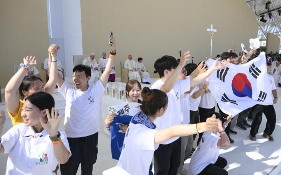 Young South Koreans cheer after Pope Francis announces that the next World Youth Day will take place in 2027 in Seoul. The pope made the announcement after the closing Mass for World Youth Day at Tejo Park in Lisbon, Portugal, Aug. 6.