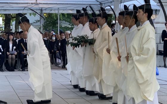 Shinto priests bow to the altar during an interfaith service at the Atomic Bomb Memorial Mound in Hiroshima, Japan, Aug. 6, 2023, to commemorate those who died in the atomic bombing of Hiroshima Aug. 6, 1945. (OSV News photo/Northwest Catholic)