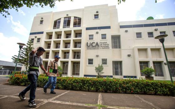 Workers walk past a building of the Jesuit-run Central American University in Managua, Nicaragua, Aug. 16, 2023. The university suspended operations Aug. 16 after Nicaraguan authorities branded the school a "center of terrorism" the previous day and froze its assets for confiscation.