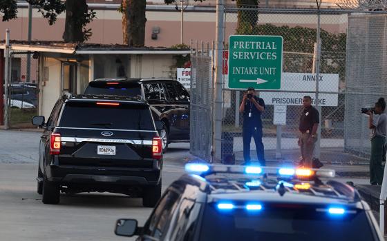 Former U.S. President Donald Trump arrives to turn himself in to be processed at Fulton County Jail in Atlanta after his Georgia indictment, Aug. 24. Trump is one of 19 defendants in the indictment that alleges racketeering by a criminal organization that tried to overturn the election results. Local authorities said Trump would be treated like any other defendant. (OSV News/Reuters/Brendan McDermid)