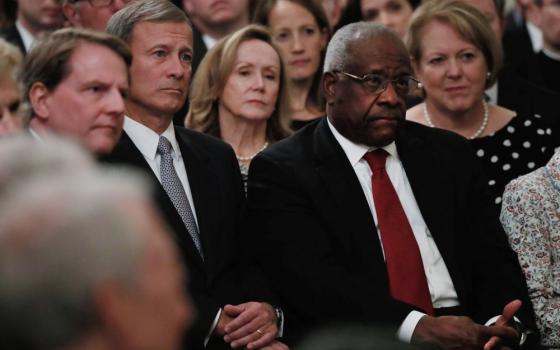 U.S. Supreme Court Chief Justice John Roberts, second from left, and Justice Clarence Thomas, both Catholic, listen during the public swearing-in ceremony for Justice Brett Kavanaugh Oct. 8, 2017, in the East Room of the White House. (CNS/Reuters/Jonathan Ernst) 