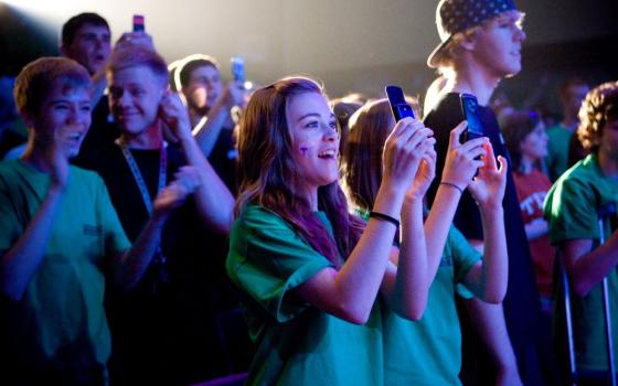 Students cheer and take photos with cellphones as singer Taylor Swift performs at Bishop Ireton High School in Alexandria, Va., April 28, 2009. (CNS/Jonathan Tramontana) 