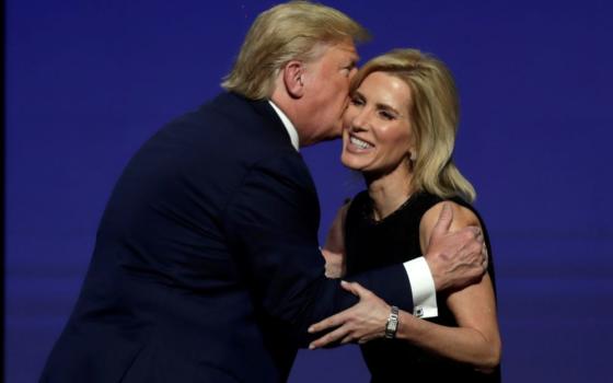Then-President Donald Trump gives Laura Ingraham a kiss after inviting her on stage during the Turning Point USA Student Action Summit at the Palm Beach County Convention Center, on Dec. 21, 2019, in West Palm Beach, Fla. After Trump was indicted on four charges Aug. 1, Ingraham invoked his right to free speech. (AP/Luis M. Alvarez, file)