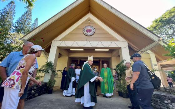 Most Rev. Clarence "Larry" Silva, the Bishop of Honolulu, greets parishioners after Mass at Sacred Hearts Mission Church in Kapalua, Hawaii, Sunday, Aug. 13, 2023.