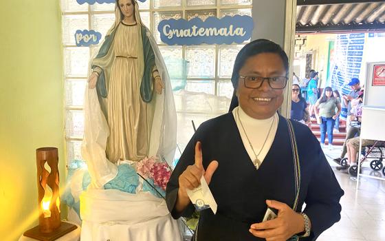 Sr. Rosa María Reyes poses for a photo in front of a statue of Our Lady of the Assumption after voting at a school Aug. 20 in Guatemala City. Guatemala wasn't just voting for a candidate but for change it desperately needs, she said. (NCR photo/Rhina Guidos)