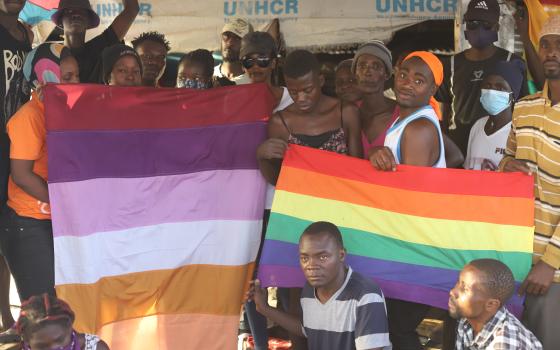 The LGBTQ refugees in Kakuma Refugee Camp, located in Kenya's northwestern region, hold their rainbow flags as they pose for a photo on Feb. 18. (NCR photo/Doreen Ajiambo)