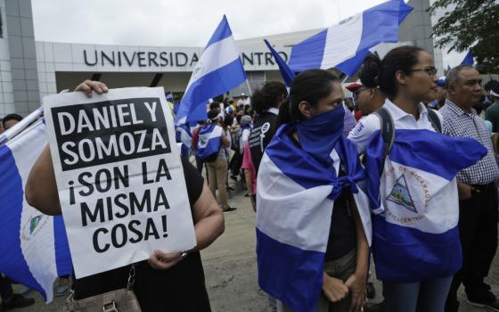 Demonstrators protest outside the Jesuit-run Universidad Centroamericana, UCA, demanding the university's allocation of its share of 6% of the national budget in Managua, Nicaragua, Aug. 2, 2018. The Jesuits announced Wednesday, Aug. 16, 2023, that Nicaragua's government has confiscated the UCA, one of the region's most highly regarded colleges. (AP Photo/Arnulfo Franco, File)