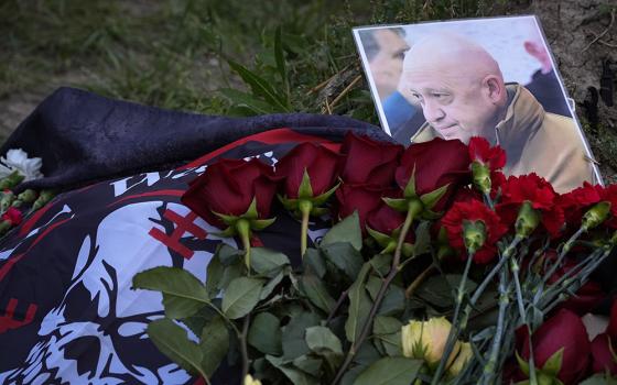 A portrait of the late Yevgeny Prigozhin, head of the Wagner mercenary group, lays at an informal memorial in St. Petersburg, Russia, Aug. 24. (AP Photo/Dmitri Lovetsky)