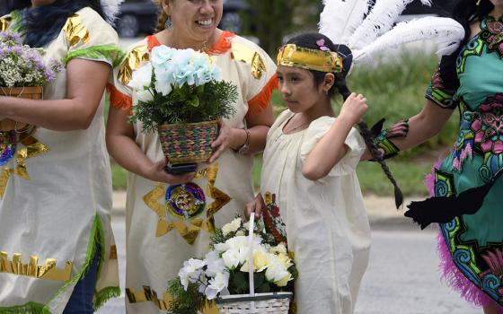 Members of Cristo Rey Parish prepare before the Parliament of the World's Religions Parade of Faiths on Sunday, Aug. 13, in Chicago. (AP/Paul Beaty)