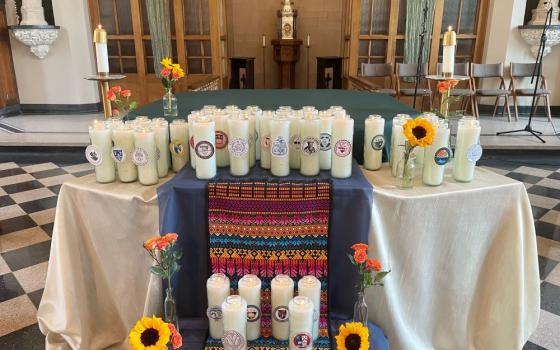 Tall candles on table in chapel