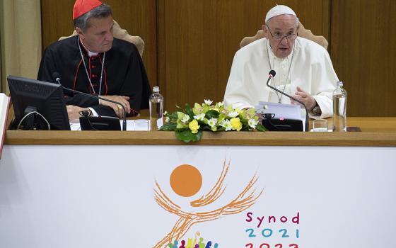 Pope Francis speaks as Maltese Cardinal Mario Grech, secretary-general of the Synod of Bishops, looks on during a meeting with representatives of bishops' conferences from around the world at the Vatican in this Oct. 9, 2021, file photo. (CNS/Paul Haring)