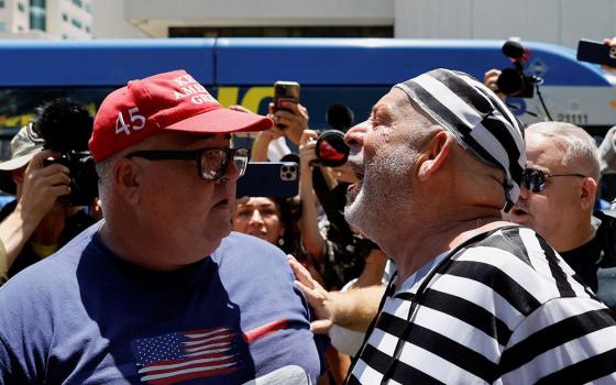 A supporter of former U.S. President Donald Trump and an anti-Trump demonstrator argue near the Wilkie D. Ferguson Jr. U.S. Courthouse, on the day Trump appeared for his arraignment on classified document charges, in Miami June 13. (OSV News/Reuters/Marco Bello)