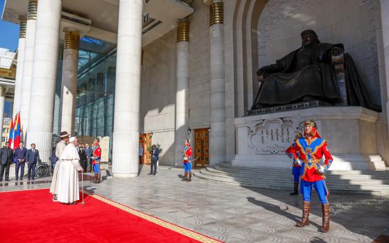 Pope Francis stands next to Mongolian President Ukhnaagiin Khürelsükh in front of a statue of Genghis Khan during an official welcome ceremony in Sükhbaatar Square in Ulaanbaatar, Mongolia, Sept. 2, 2023. (CNS photo/Lola Gomez)