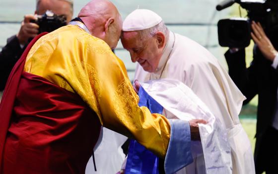 Pope Francis receives a scarf as a gift from Choijiljav Dambajav, abbot of the Buddhists' Zuun Khuree Dashichoiling Monastery in Ulaanbaatar, Mongolia, during an ecumenical and interreligious meeting at the city's Hun Theatre Sept. 3, 2023. (CNS photo/Lola Gomez)