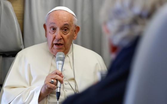 Pope Francis answers questions from journalists aboard his flight back to Rome from Ulaanbaatar, Mongolia, Sept. 4, 2023, after a four-day visit to the Asian country. (CNS photo/Lola Gomez)